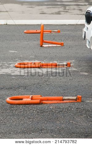 Orange parking barriers in the parking lot near the Russian store.