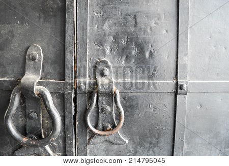 Door knocker on old, black, iron gates
