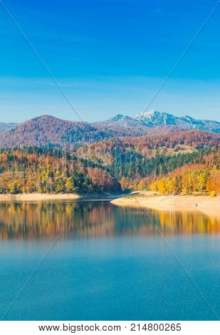 Panoramic view of Lokvarsko lake with Risnjak mountain in background, beautiful colorful mountain autumn landscape, Lokve, Gorski kotar, Croatia