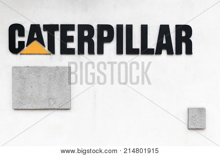 Grenoble, France - June 26, 2017: Caterpillar logo on a wall. Caterpillar is an American corporation which designs, develops, engineers, manufactures, markets and sells machinery, engines