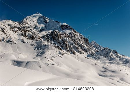 Beautiful winter landscape of the mountains covered with bright snow under the clear blue sky