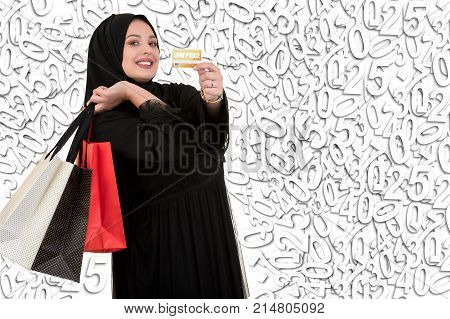 Happy standing muslim woman with shopping bag and credit card with holidays illustration