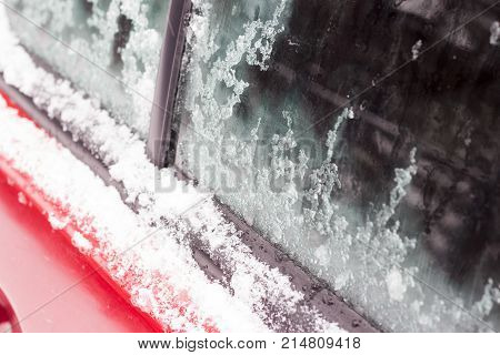 Car on the street covered by icy rain.