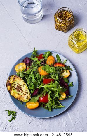 Raw arugula with vegetables and citrus. Selective focus.