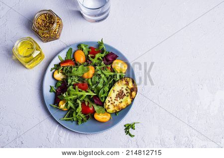 Raw arugula with vegetables and citrus. Selective focus.