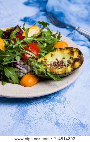 Raw arugula with vegetables and citrus. Selective focus.