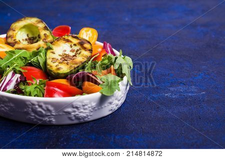 Raw arugula with vegetables and citrus. Selective focus.