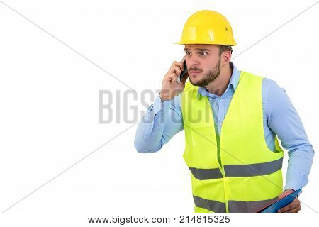 Angry upset young construction engineer yeling at the phone.