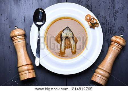 Fish Soup With Piece Of Fish And Fried Onion Rings