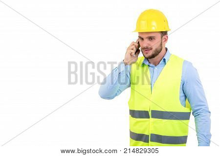Angry upset young construction engineer yeling at the phone.
