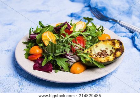 Raw arugula with vegetables and citrus. Selective focus.