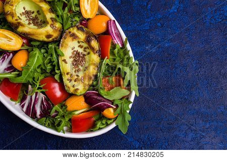 Raw arugula with vegetables and citrus. Selective focus.