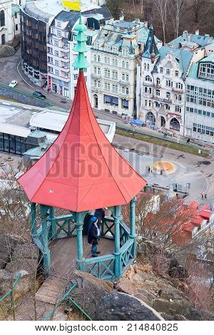Karlovy Vary, Czech Republic - February 24, 2017: People at Peter's Height lookout tower and Karlovy Vary, aerial panoramic famous spa town view, Czech Republic