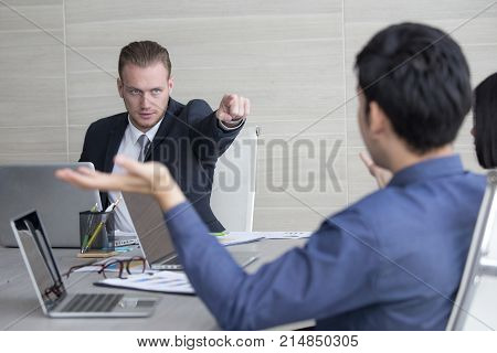 Young Business People Working Together With Serious Emotion. Business People Pointing To Team With A