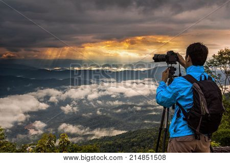 Photograph taking shot of Fantastic Landscape of Misty Mountain with sun rays at doi samer dao view point Nan province north of Thailand.