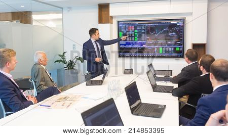 Businessman giving a talk in conference room. Business executive delivering presentation to business partners during business meeting. Corporate business concept.