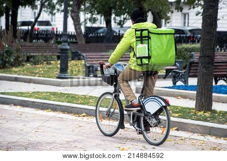delivery man on the bike in the city roadway
