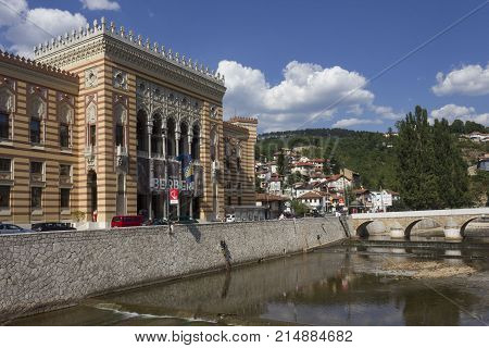 SARAJEVO, BOSNIA-HERZEGOVINA - AUGUST 18 2017: Sarajevo City hall and the riverbank of Miliajka river in Sarajevo