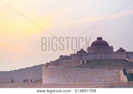 Close up shot of the Ambedkar stupa at sunset. The path leading to the top and the domed roof are clearly visible