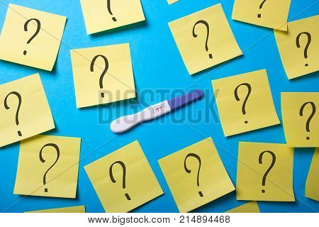 How to know the gender of the child. Why do I get pregnant? Contraceptives do not work. Positive pregnancy test with two strips and office stickers with a question mark.