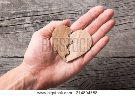 Find your soul mate love. Paper heart of the two halves combined together man holds in hand