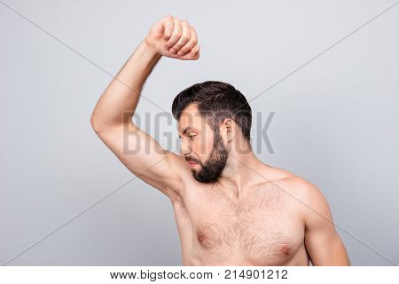 Close Up Portrait Of Man With Bristle, Smelling His Armpit, Feeling Bad Odor, Wants To Take A Shower