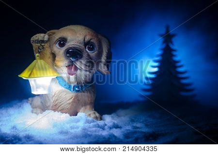 Toy Dog - A Symbol Of The New Year Under The Snow Against The Background Of Fir Branches. Toy's Dog 