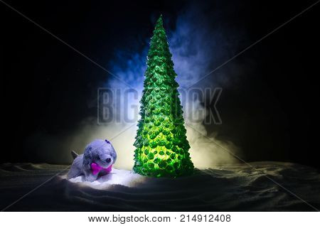 Toy Dog - A Symbol Of The New Year Under The Snow Against The Background Of Fir Branches. Toy's Dog 