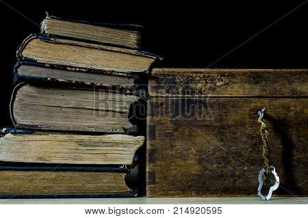 Old Rolls And Plans In Folded Paper Rolls. Old Book And Case. Documents On An Old Wooden Table.