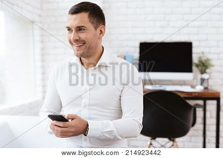 Young man smiles after the divorce. He is in the office of a lawyer. He is happy, he is in a good mood.