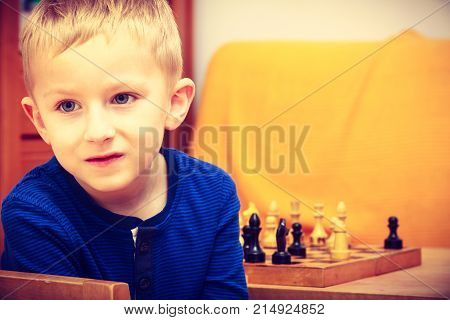 Young Kid Boy Playing Chess Having Fun