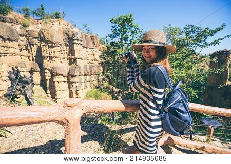 Young asian woman traveler travelling to wonderful soil cliff Pha Cho at Mae Wang National Park Doi Lo district Chiang Mai Thailand.