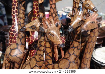 Wood carvings of giraffes sold by hawkers on the street in Simonstown, South Africa