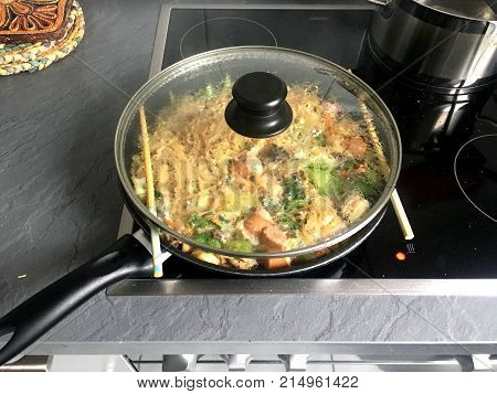 Cooking the Asian fried noodle on a modernized Electric ceramic heaters.