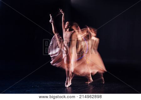 Professional female dancer. Serious nice well built woman holding her leg up and showing her mastery while dancing