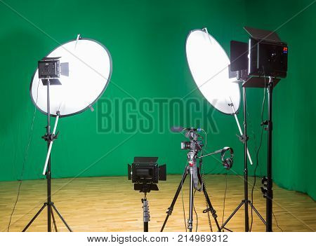 Studio for filming on a green background. The chroma key. Lighting equipment in the Studio. Green screen.