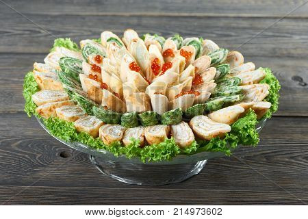 Plate full of delicious pancake rolls with creamy filling and caviar decorated on top food eating restaurant cafe cooking kitchen recipe tasty hungry serving dish gourmet menu concept