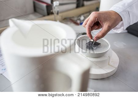 Hands of a scientist working in modern chemistry/physics lab (shallow DOF; color toned image)
