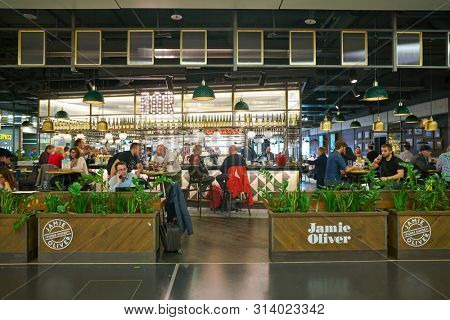 VIENNA, AUSTRIA - CIRCA MAY, 2019: people at Jamie Oliver in Vienna International Airport.