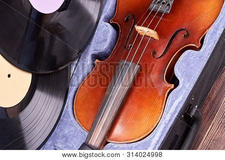 Vintage Violin And Vinyl Records. Retro Viola In Velvet Case. Old Musical Equipment.