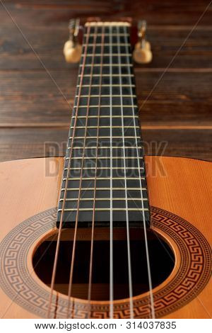 Six-strings Guitar, Vertical Image. Acoustic Guitar Close Up. Classical Music Instrument.