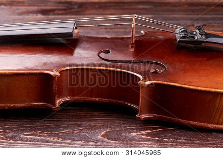 Detail Of Violin Waist. Close Up Old Violin Bridge, Cropped Image. Instrument Which Create A Melody.