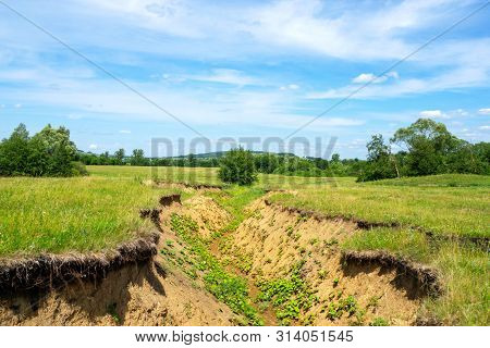 A Deep Ravine Caused By Soil Erosion From Spring Thawed Snow.