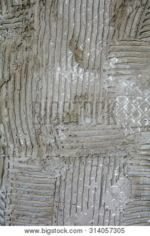 Rusty Concrete Surface With Striped Relief. Texture With Engraved Lines On Urban Cement Wall. Txture