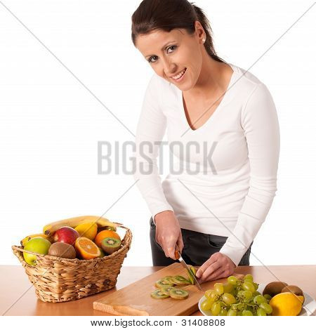 Attractive Young Woman Cuting Fruits And Preparing Fruit Salad