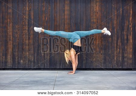 Beautiful Athletic Young Girl Gymnast In Sportswear, Working Out, Element Of Gymnastics, Doing The S