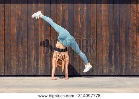 Beautiful Athletic Young Girl Gymnast In Sportswear, Working Out, Element Of Gymnastics, Doing The S