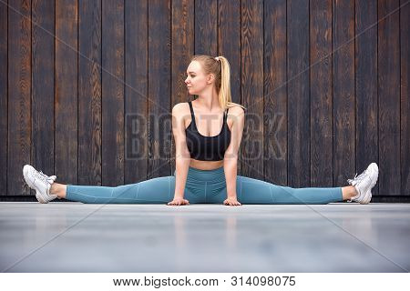 Beautiful Athletic Young Girl Gymnast In Sportswear, Working Out, Element Of Gymnastics, Doing The S