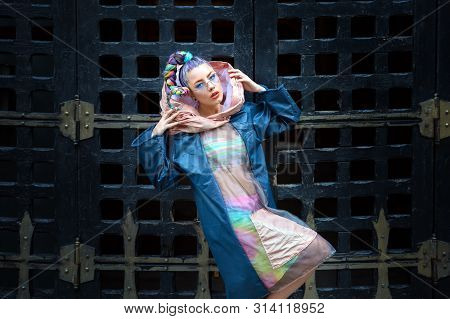 Street fashion model outfit on funky girl model with crazy hair - Avant garde style with hipster woman wearing glamour trendy pop culture stylish clothes - extreme fashionista statement