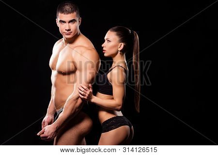 Youthful Fit Girl Touches Athlete. Young Fitness Model Touches Bodybuilder. Young And Uninhibited. D
